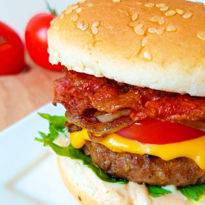 Juicy burger with crispy bacon and homemade sauce