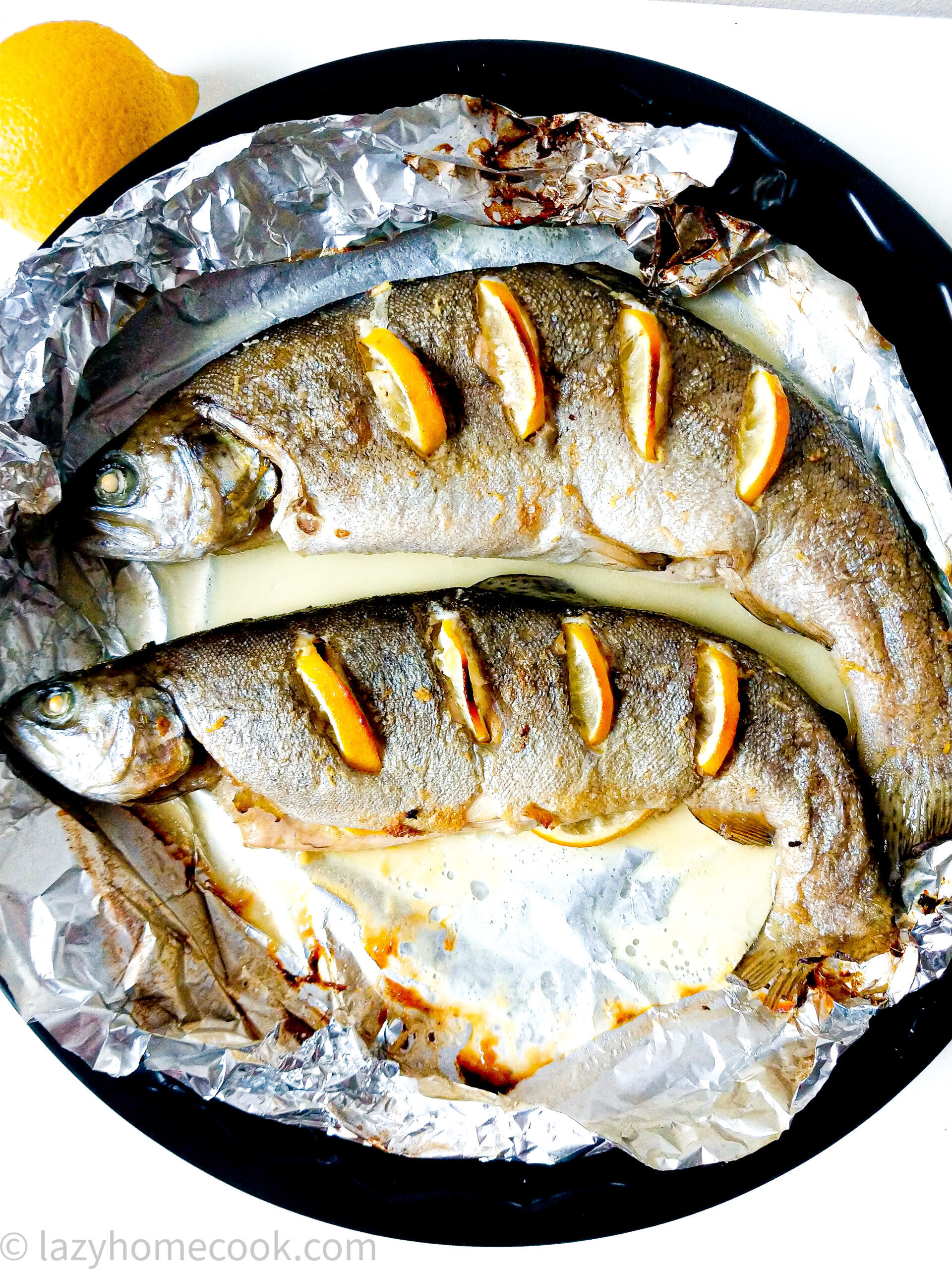 Oven baked whole trout with lemon, ginger and white wine